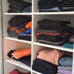 Wardrobe interior featuring fixed shelving for folded clothes and organised storage