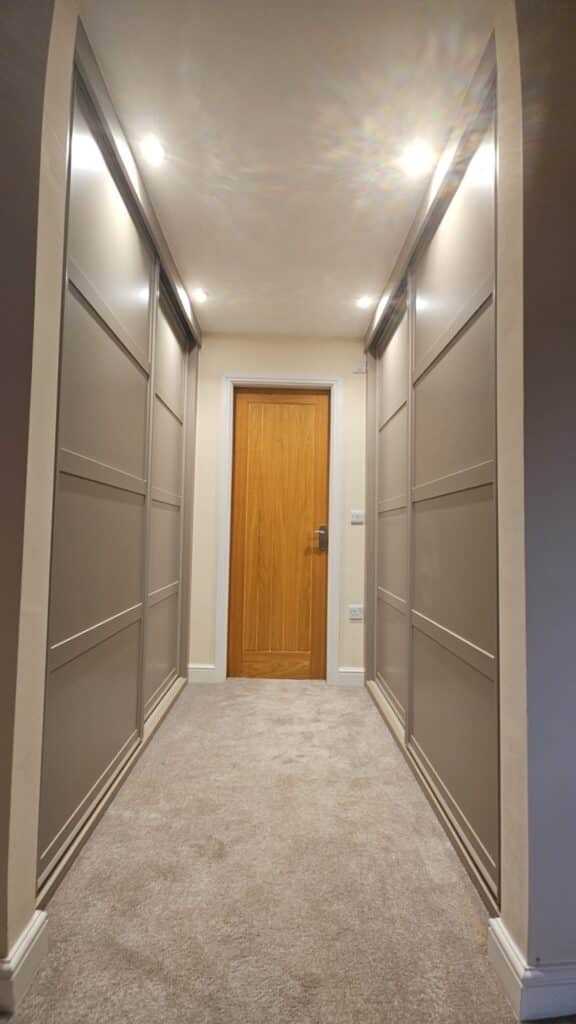 Shaker style sliding door wardrobes fitted in a hallway in Chorley, Lancashire