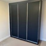 3 door sliding wardrobe with silver frames and black doors