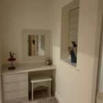 Made-to-measure dressing table with wall mounted feature mirror and stool to match.