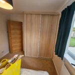 2 door sliding wardrobe with white frame and light wood doors