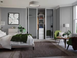 4 door sliding wardrobe with mirror doors and white frame. Open to show hanging rail, shelves and drawers.