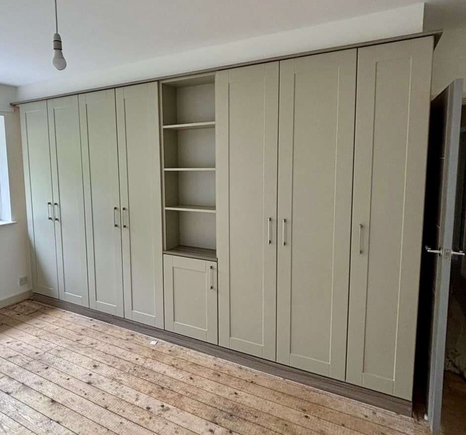 Replacement bespoke wardrobe doors in the Shaker style, Neutral finish with the addition of a shelving unit.