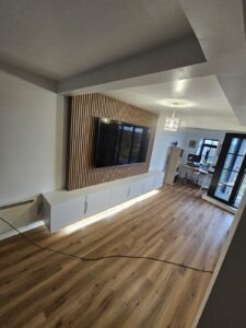 Media Unit - floating white handless cupboards and wall panelling