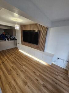 Media Wall - floating white handless cupboards and wall panelling