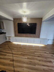 Media Wall- floating white handless cupboards and wall panelling