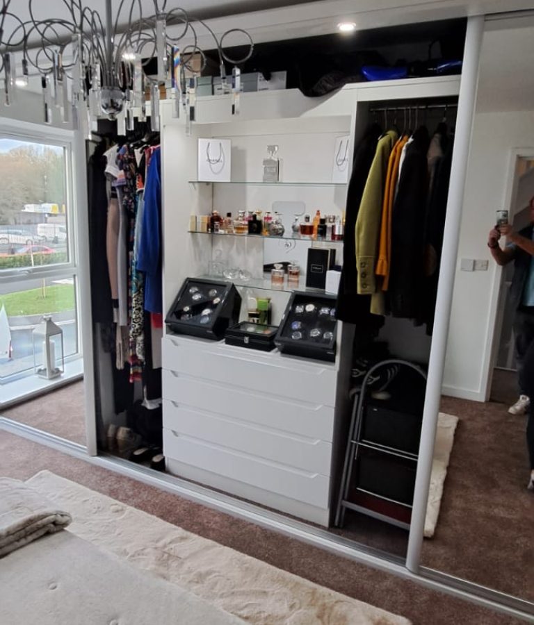 Premium glass shelves in a wardrobe paired with lighting for showcasing decorative items or accessories.