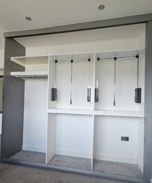 Pull-down wardrobe hanging rail designed for easy-access clothes storage.