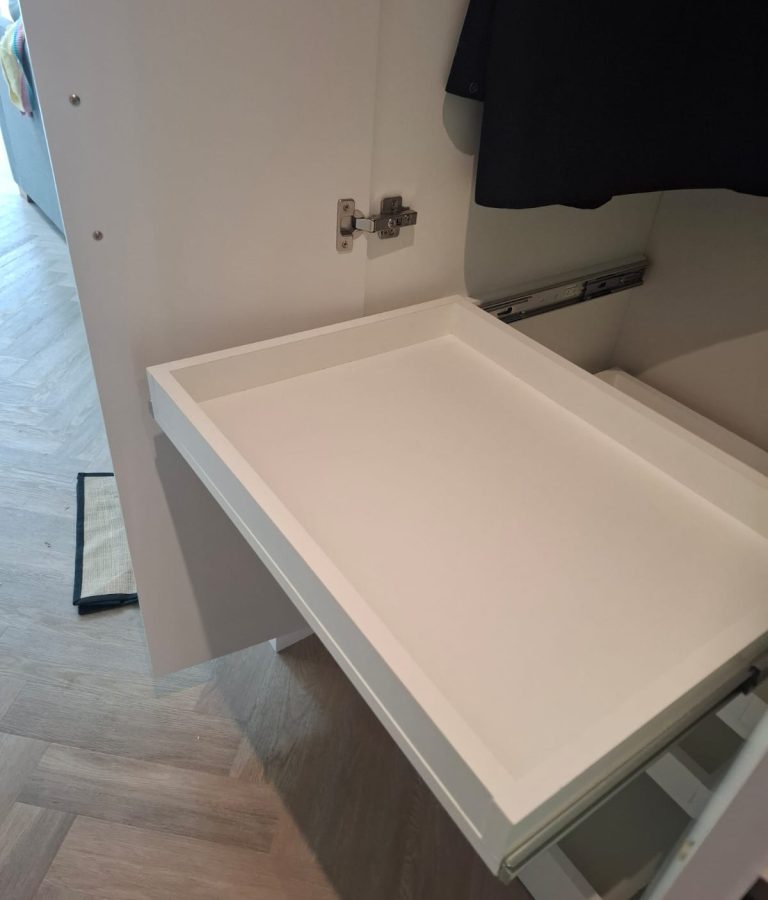 Wardrobe pull-out tray for accessories, folded items or storage baskets.