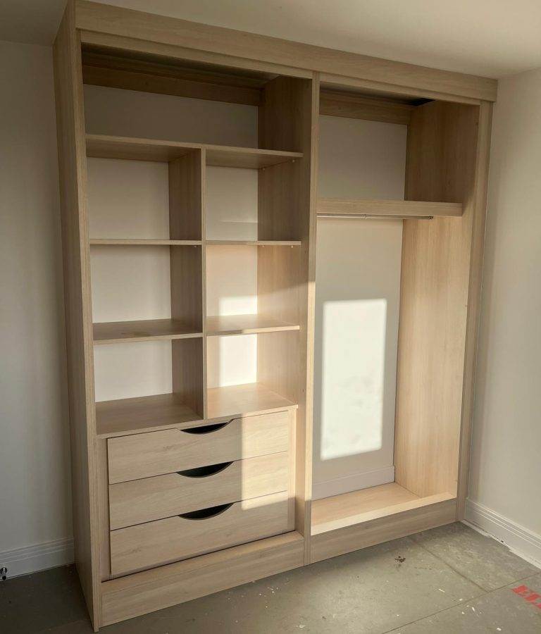 Wardrobe interior featuring fixed shelving for folded clothes and organised storage